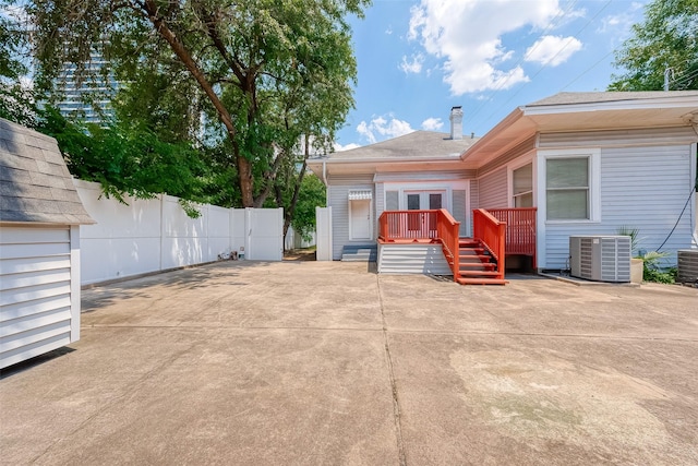 exterior space with cooling unit and a wooden deck