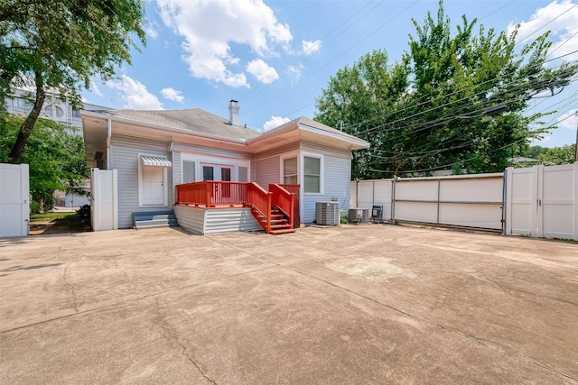 rear view of house featuring central AC