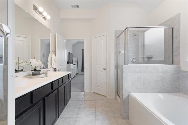 bathroom with tile patterned floors, shower with separate bathtub, and vanity