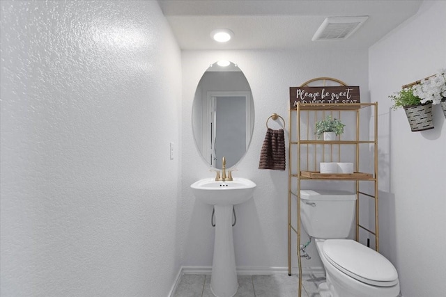 bathroom featuring tile patterned flooring and toilet