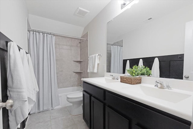 full bathroom with tile patterned floors, toilet, vanity, and shower / bath combo