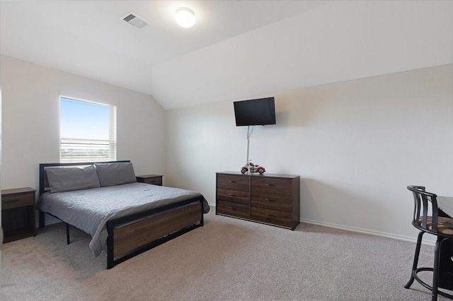 carpeted bedroom with lofted ceiling