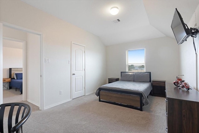 bedroom with lofted ceiling and light carpet