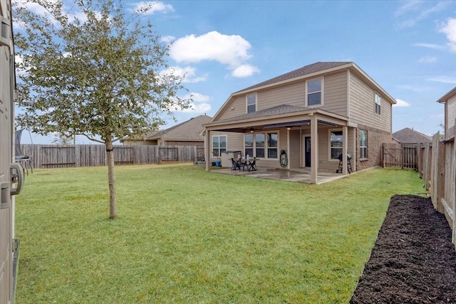 back of house featuring a yard and a patio area