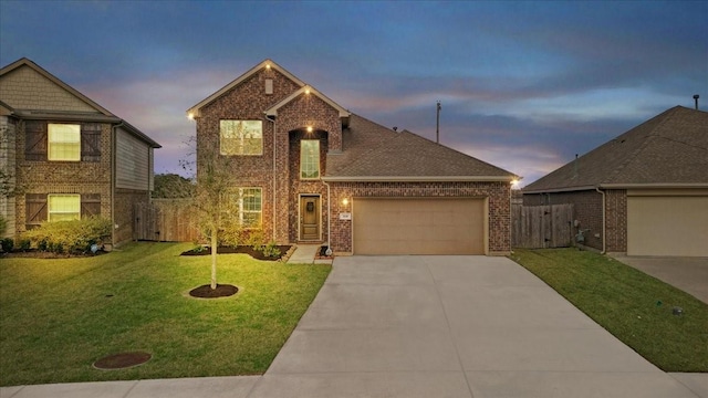 view of front of property with a garage and a lawn