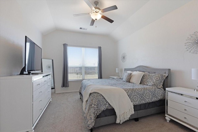 bedroom with ceiling fan, light colored carpet, and vaulted ceiling