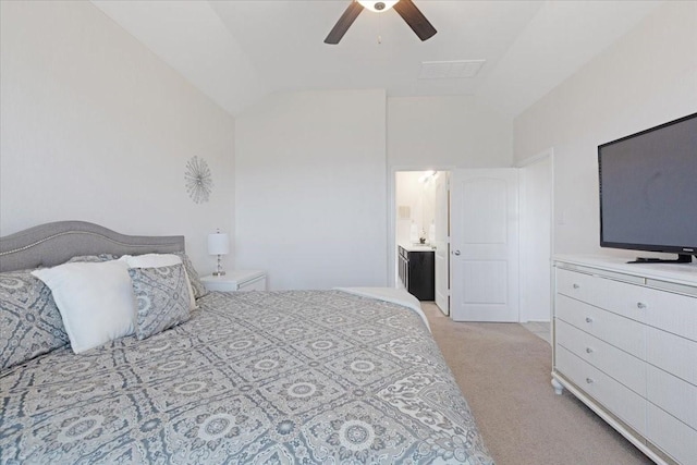 bedroom with ensuite bathroom, lofted ceiling, light carpet, and ceiling fan