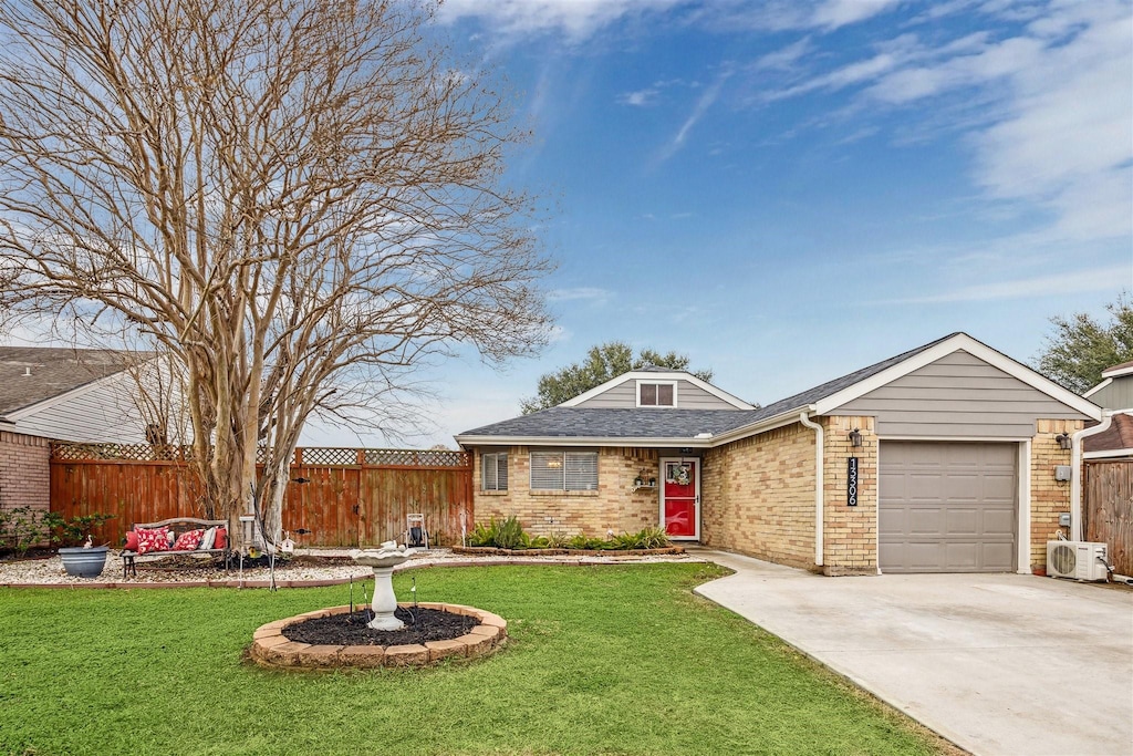 ranch-style home featuring a garage, ac unit, and a front yard