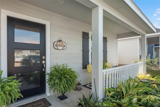 view of exterior entry featuring a porch