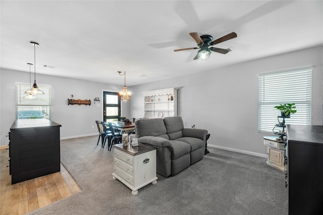 living room featuring ceiling fan and dark carpet