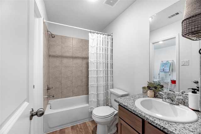 full bathroom with vanity, toilet, hardwood / wood-style floors, and shower / bath combo