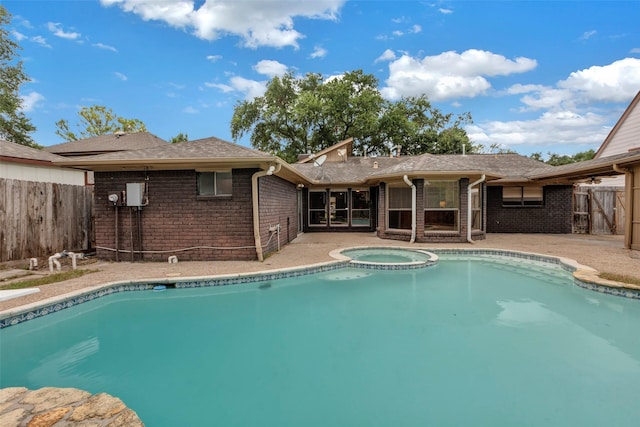 view of pool featuring a patio and an in ground hot tub