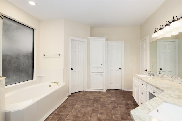 bathroom with vanity and a washtub