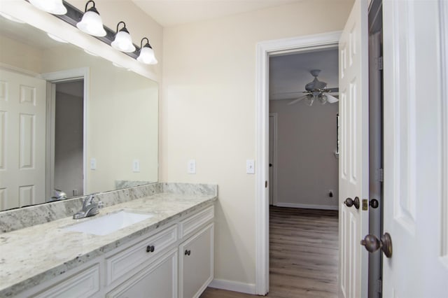 bathroom featuring hardwood / wood-style flooring, vanity, and ceiling fan