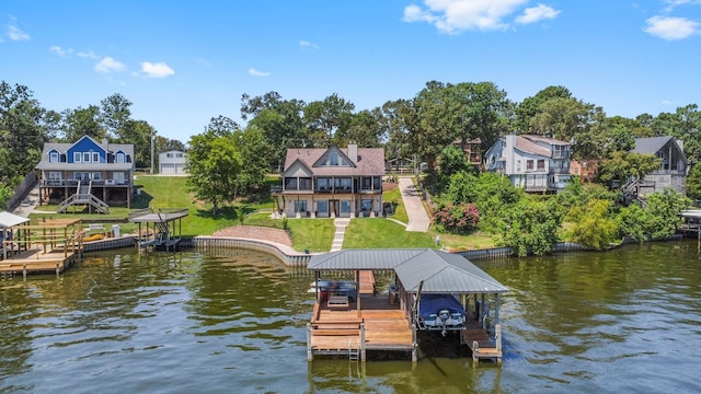 dock area with a water view and a yard