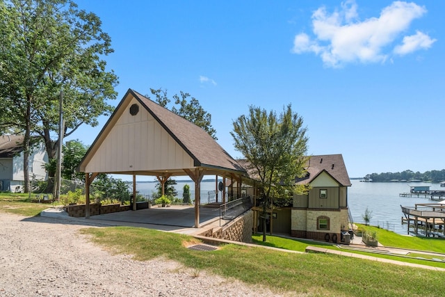 surrounding community with a yard, a gazebo, and a water view