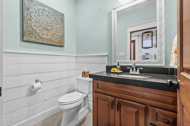 bathroom with vanity, toilet, and tile patterned flooring