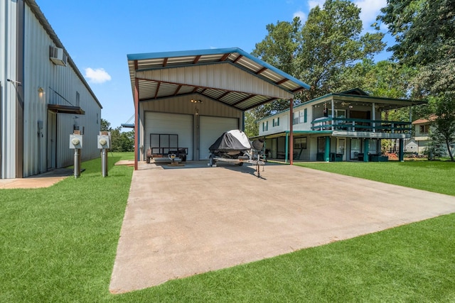 back of house featuring a yard, a garage, an outdoor structure, and a wall unit AC