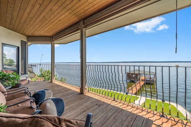 wooden terrace featuring a water view