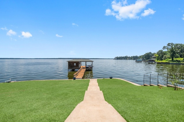 dock area with a water view and a lawn