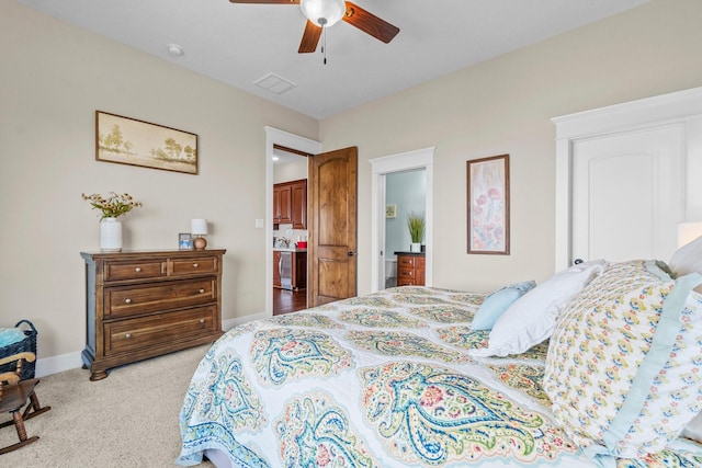 carpeted bedroom with ceiling fan and connected bathroom