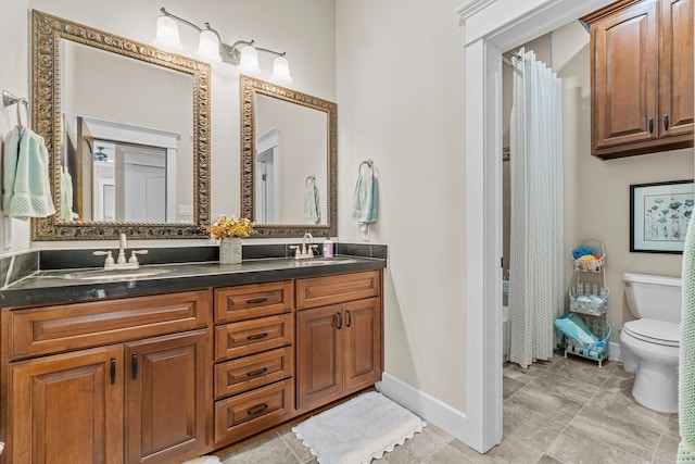 bathroom featuring vanity, toilet, and tile patterned flooring