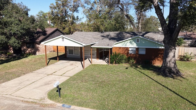 ranch-style house featuring a carport and a front lawn