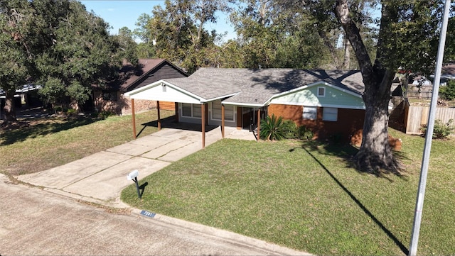 single story home featuring a front yard and a carport