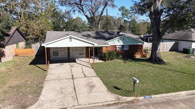 ranch-style home featuring a front yard and a carport