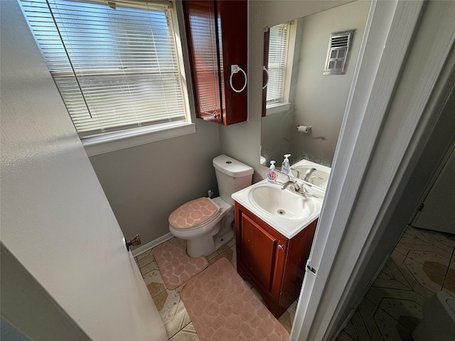 bathroom with vanity, tile patterned floors, and toilet