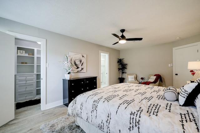 bedroom with ceiling fan and wood-type flooring