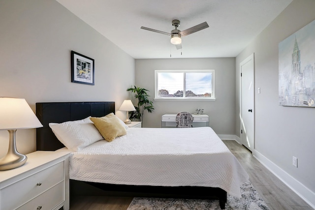 bedroom with ceiling fan and light hardwood / wood-style floors