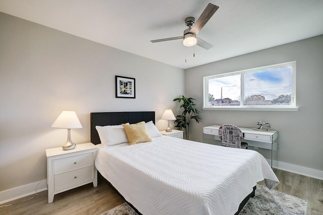 bedroom with ceiling fan and light hardwood / wood-style flooring