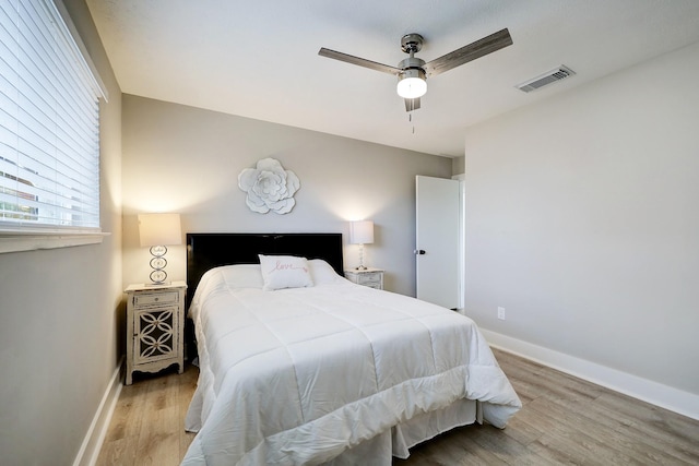 bedroom with ceiling fan and light wood-type flooring