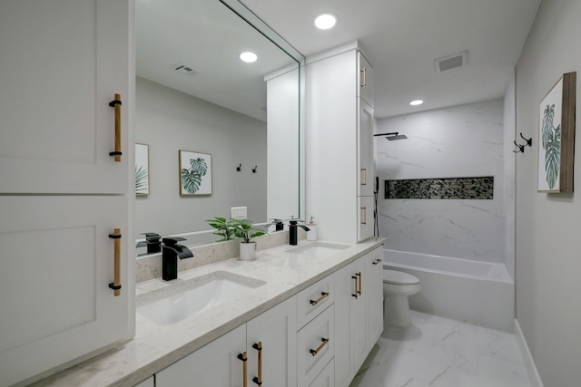 full bathroom with vanity, toilet, and tiled shower / bath