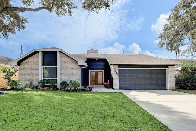 single story home with french doors, a garage, and a front yard