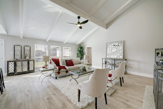 living room featuring beam ceiling, light hardwood / wood-style flooring, high vaulted ceiling, and ceiling fan