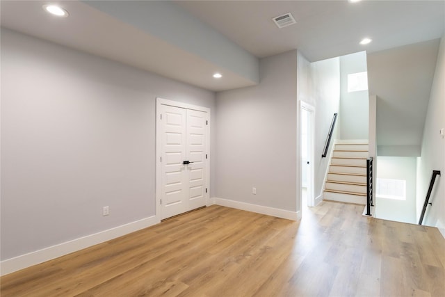 basement with light hardwood / wood-style flooring