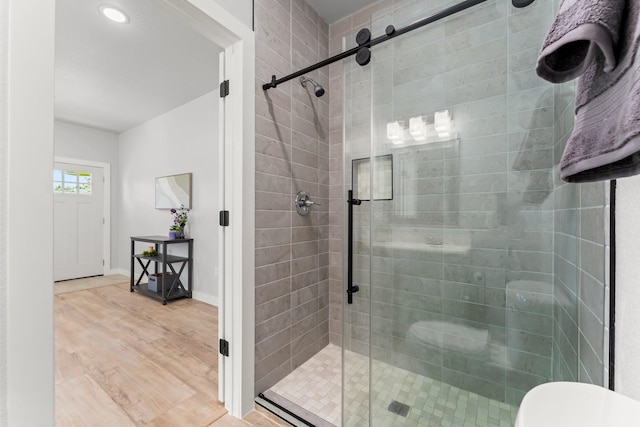 bathroom featuring hardwood / wood-style flooring and an enclosed shower