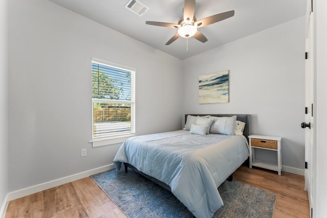 bedroom with ceiling fan and light hardwood / wood-style flooring