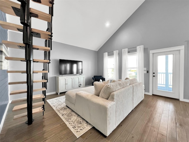 living room with wood-type flooring and high vaulted ceiling