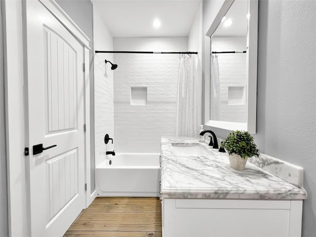 bathroom featuring shower / tub combo with curtain, wood-type flooring, and vanity