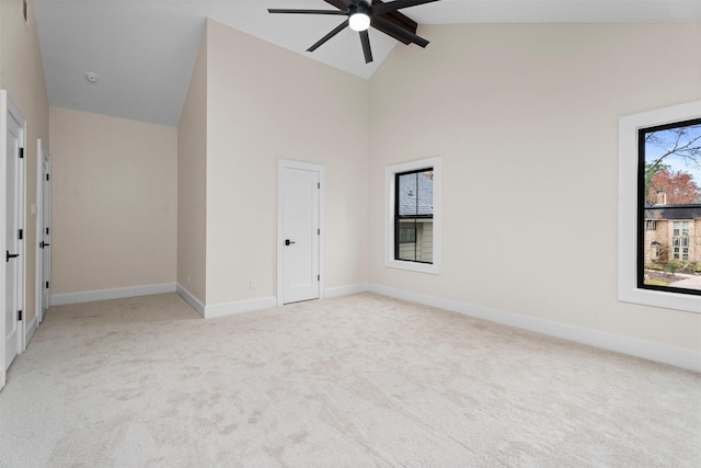 carpeted spare room with beamed ceiling, ceiling fan, and high vaulted ceiling