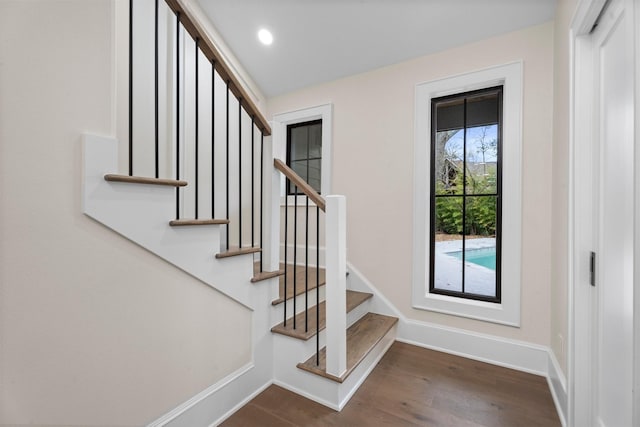 stairway featuring wood-type flooring