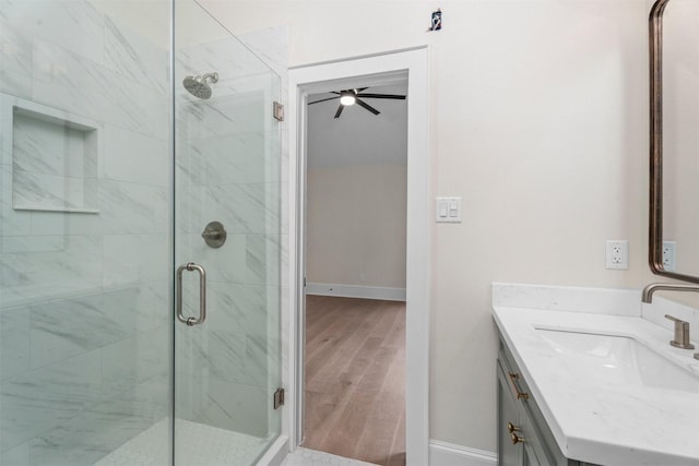 bathroom with vanity, hardwood / wood-style flooring, and walk in shower