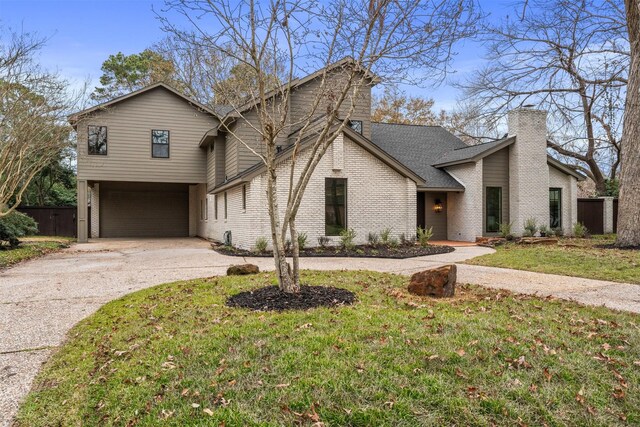 view of front facade with a garage and a front lawn