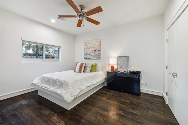 bedroom with a baseboard radiator, dark hardwood / wood-style floors, and ceiling fan