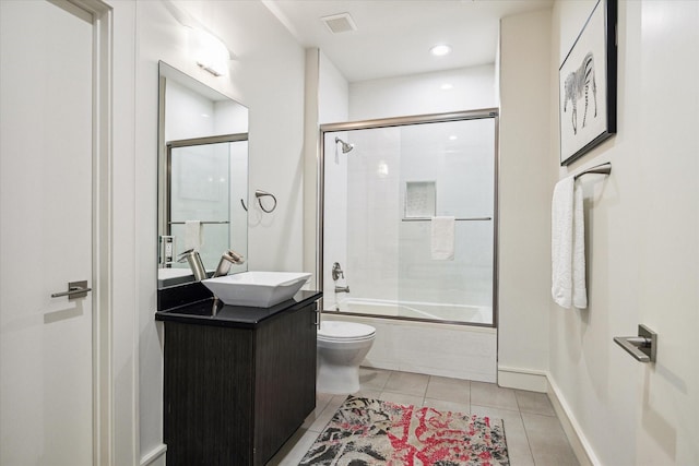 full bathroom featuring enclosed tub / shower combo, vanity, toilet, and tile patterned flooring