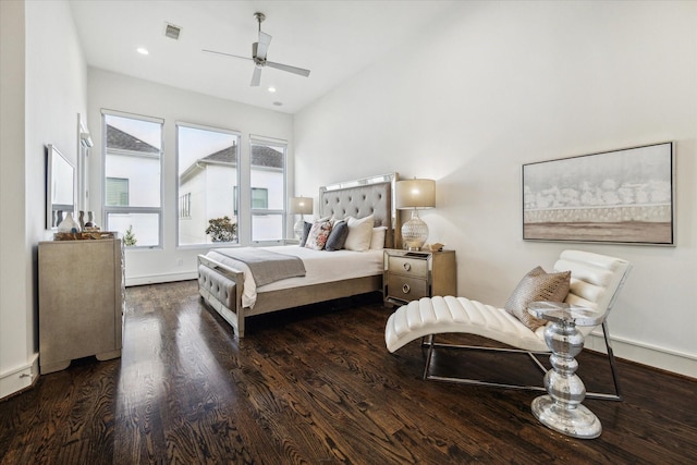 bedroom with dark hardwood / wood-style flooring and ceiling fan