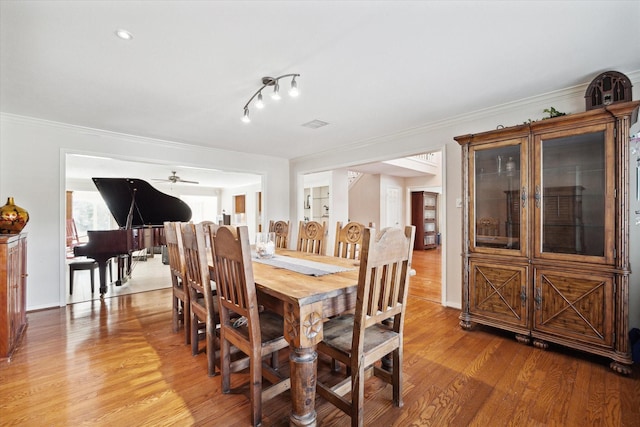 dining area featuring crown molding and hardwood / wood-style floors